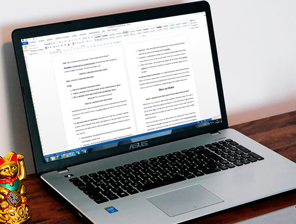 Writing a cause and effect essay on a laptop